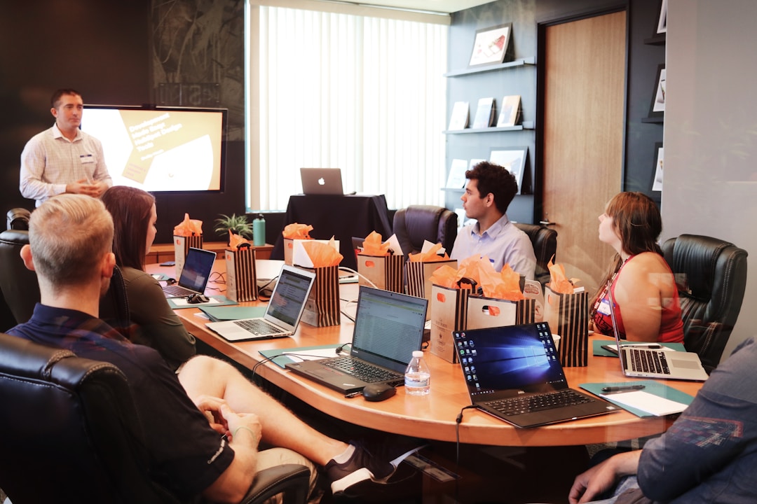 A team in an office discussing proposal management during a meeting