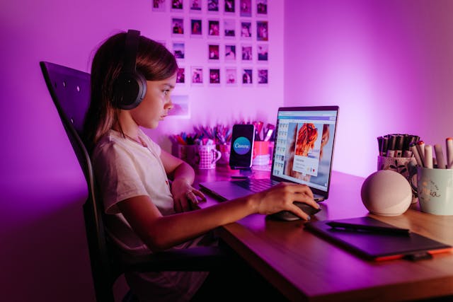 A small girl working on her laptop